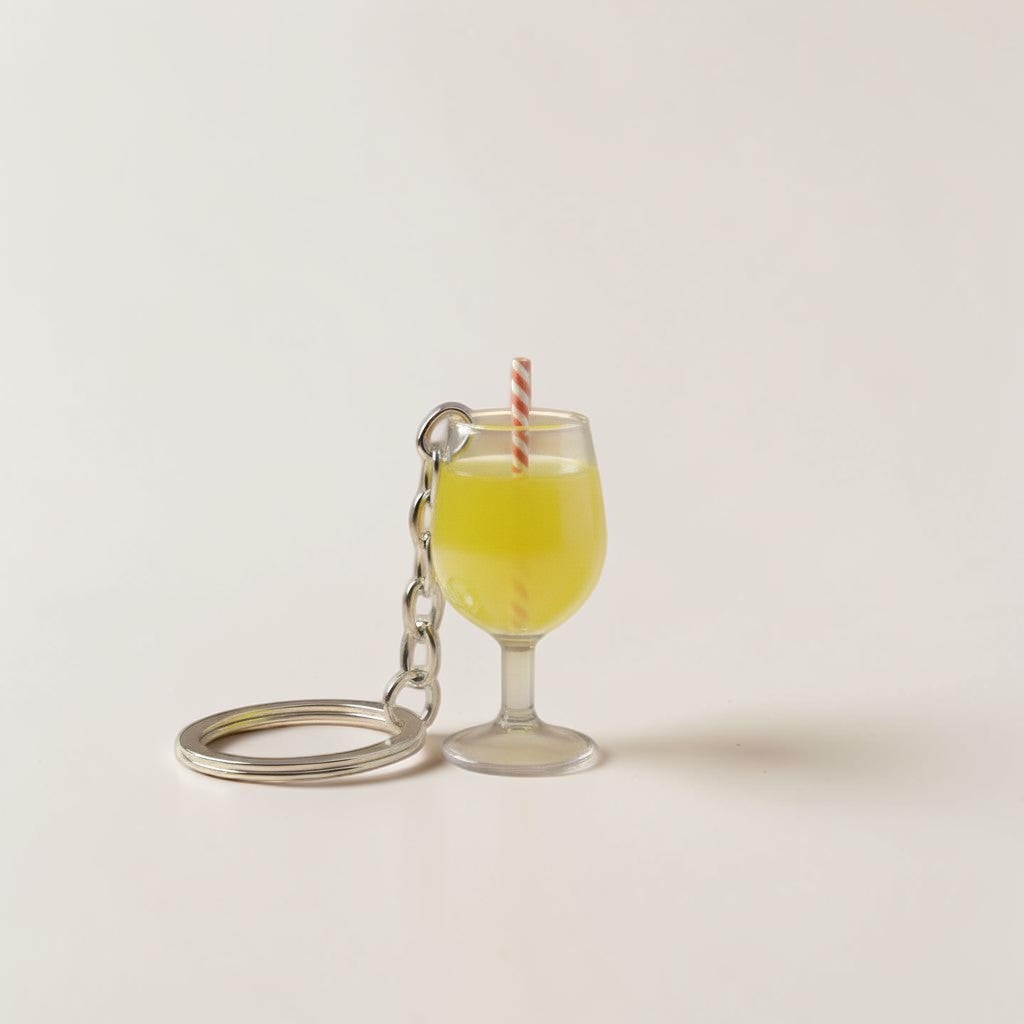 Il mio negozio Aperitivo keychain, a miniature orange spritz cocktail in a wine glass with lemon slices and a straw.
