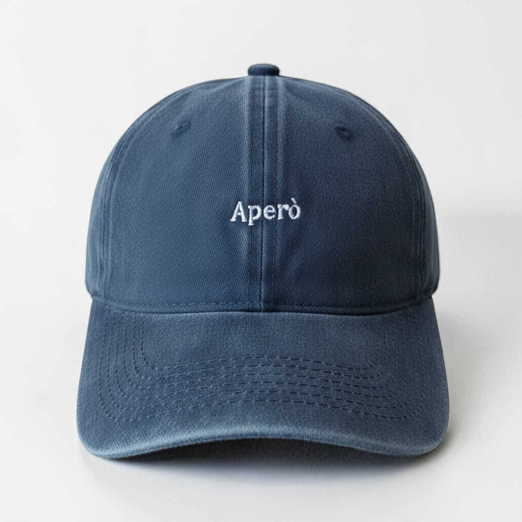 Il mio negozio navy blue washed cotton baseball cap with "Aperò" embroidered in white. Casual style.