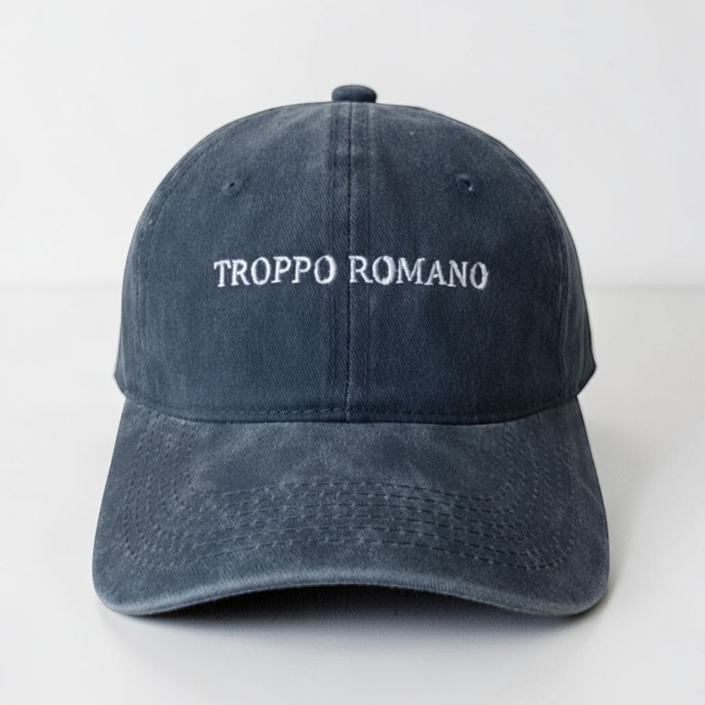 Il mio negozio navy blue washed cotton dad hat with "Troppo Romano" embroidered in white. Features a pre-curved brim and adjustable buckle.